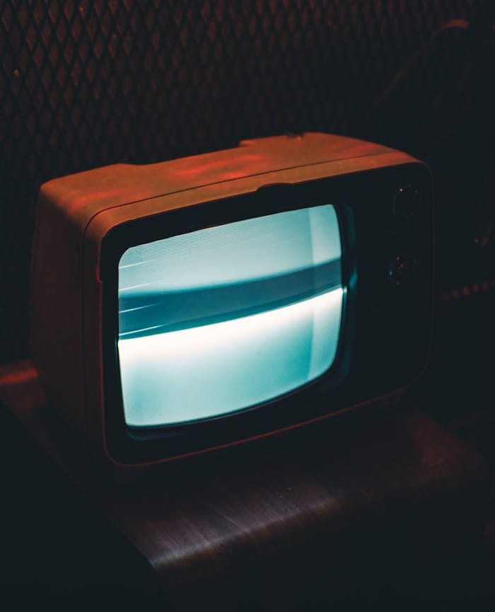 A vintage television glowing in a dark, retro ambiance.