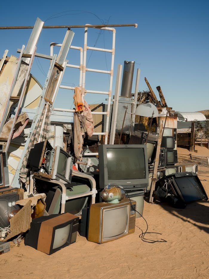 services-02 Abandoned TVs stacked in the Joshua Tree desert at a makeshift junkyard.